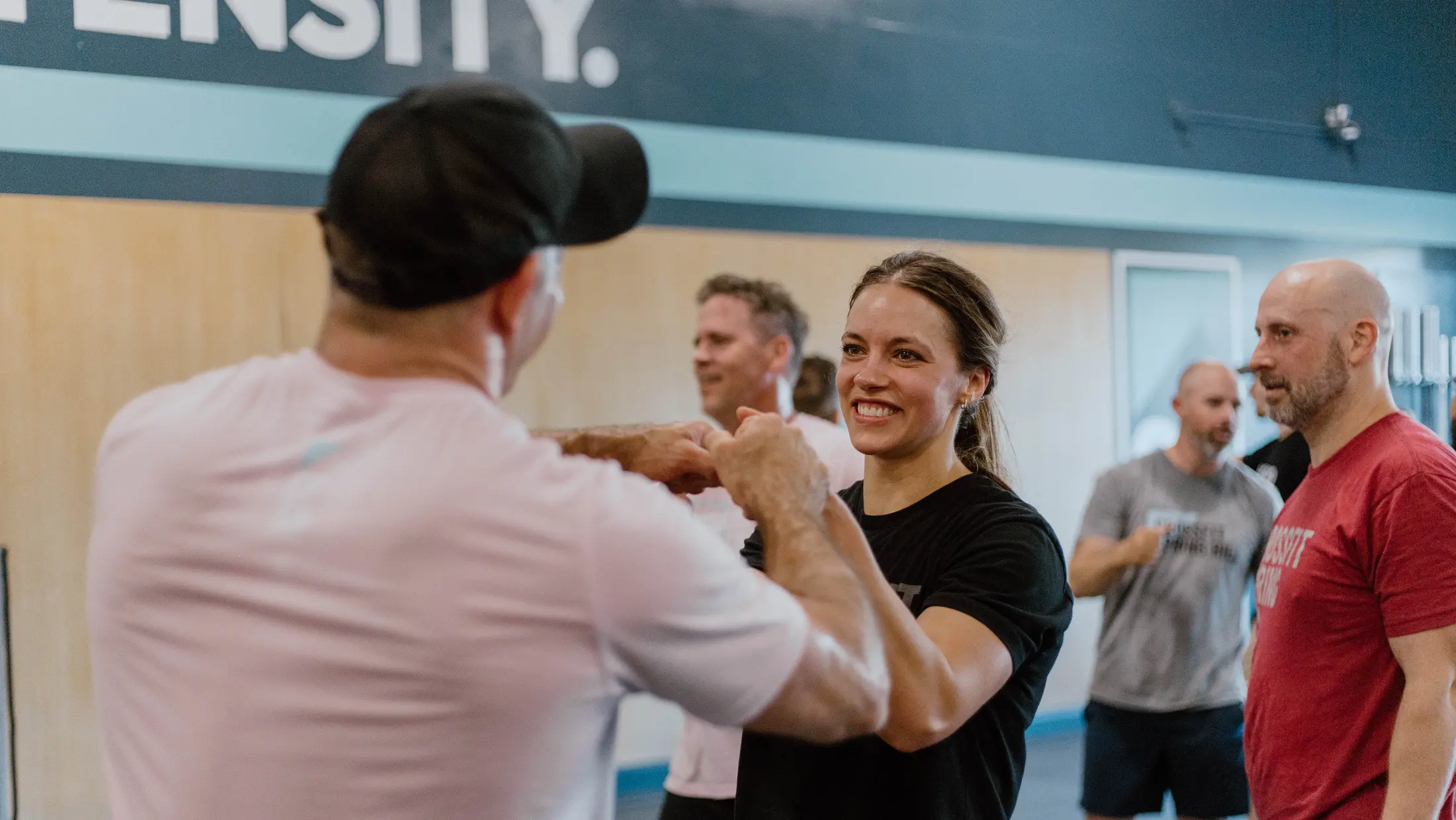 Smiling members fist bumping after a group class at CrossFit Spring Hill in Spring Hill, TN