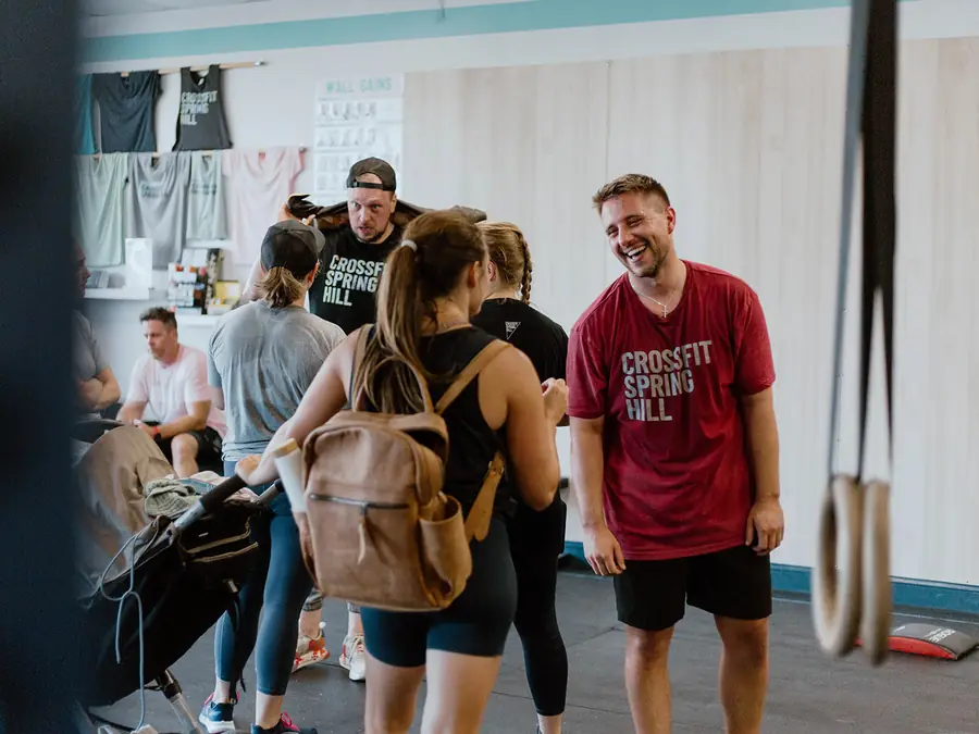 Members laughing and talking before a group class at CrossFit Spring Hill