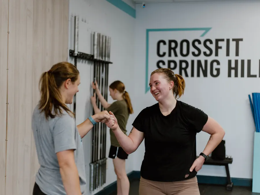 Two members fist bumping after a workout at CrossFit Spring Hill