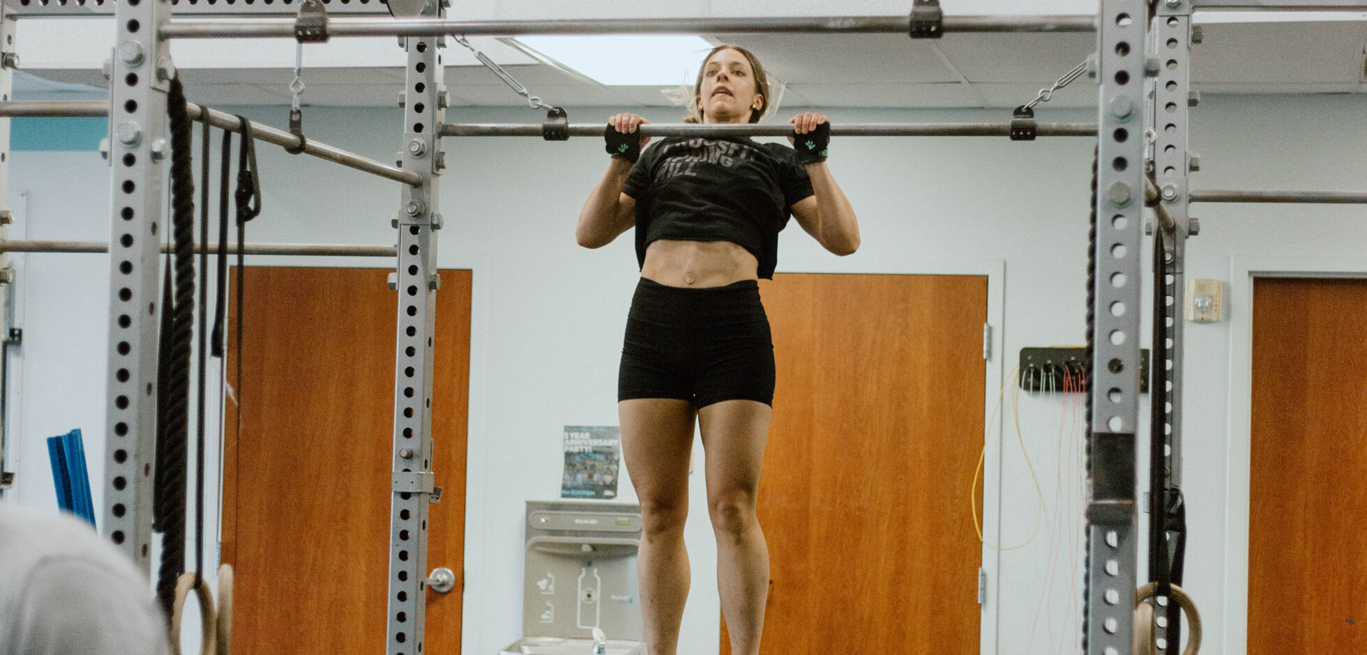 This image shows an athlete performing a full range of motion pull-up.