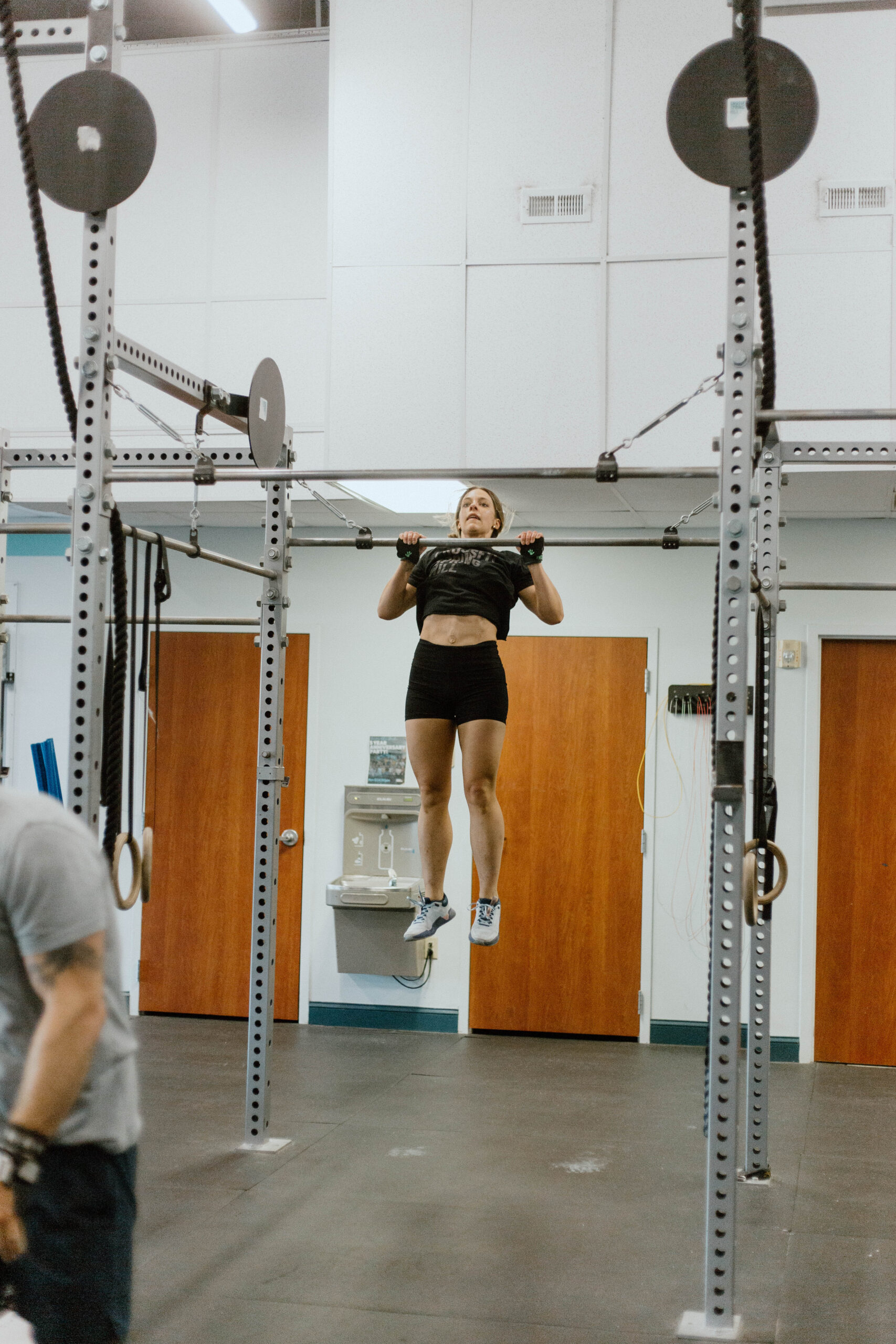 This image shows an athlete performing a full range of motion pull-up.